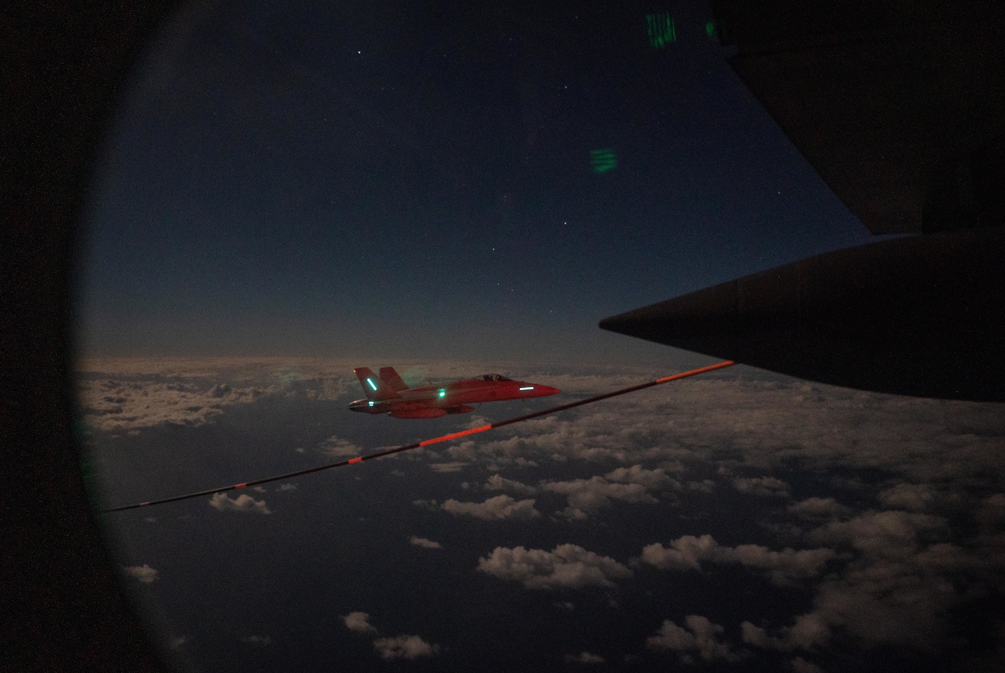 An F/A-18 Hornet fighter aircraft prepares to connect with an HC-130J Combat King II aircraft for high-speed air-to-air refueling Oct. 26, 2023 off the eastern South Carolina coast.