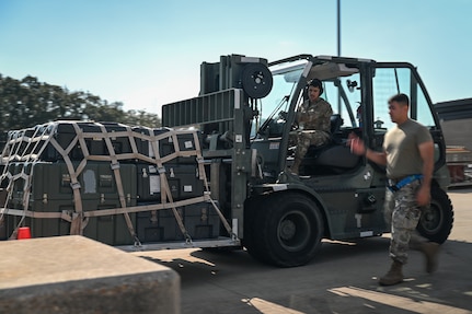 Airmen driving forklift