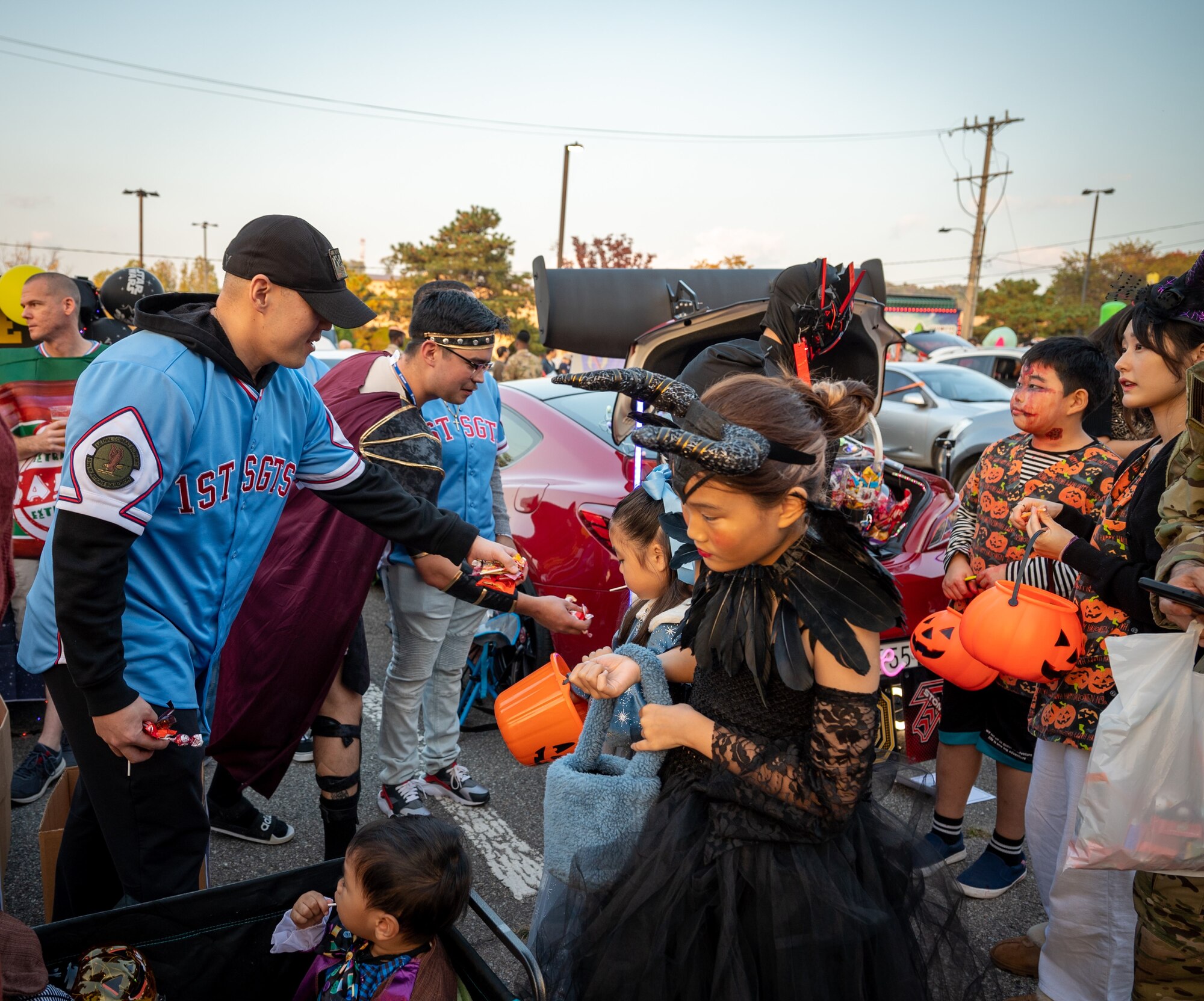 Children collect candy from members of the First Sergeant’s Association during the Trunk-or-Treat event at Osan Air Base, Republic of Korea, Oct. 27, 2023. The event created a fun and safe environment for military members and their families to enjoy Halloween activities such as food, games and costume contests to foster community morale. (U.S. Air Force photo by Staff Sgt. Kelsea Caballero)