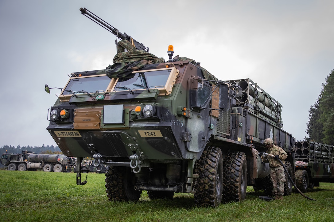 A soldier refuels M977 cargo truck.