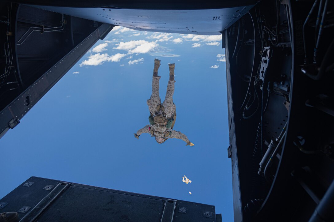A Marine jumps out of an aircraft.