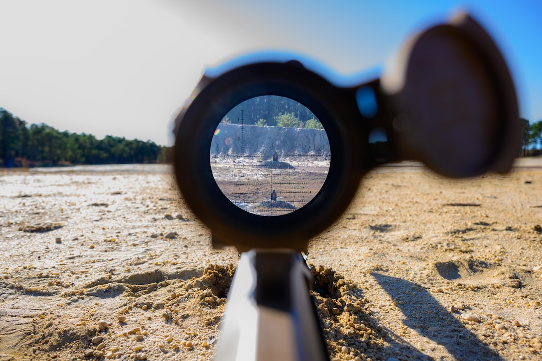 A look through the scope of a sniper rifle on a target range.