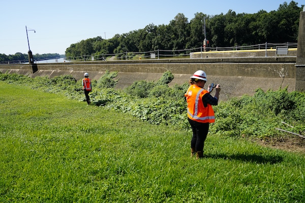Louisville District’s Kate Brandner and Melanie Babin inspect the surroundings of the lock wall at Green River Lock and Dam No. 1