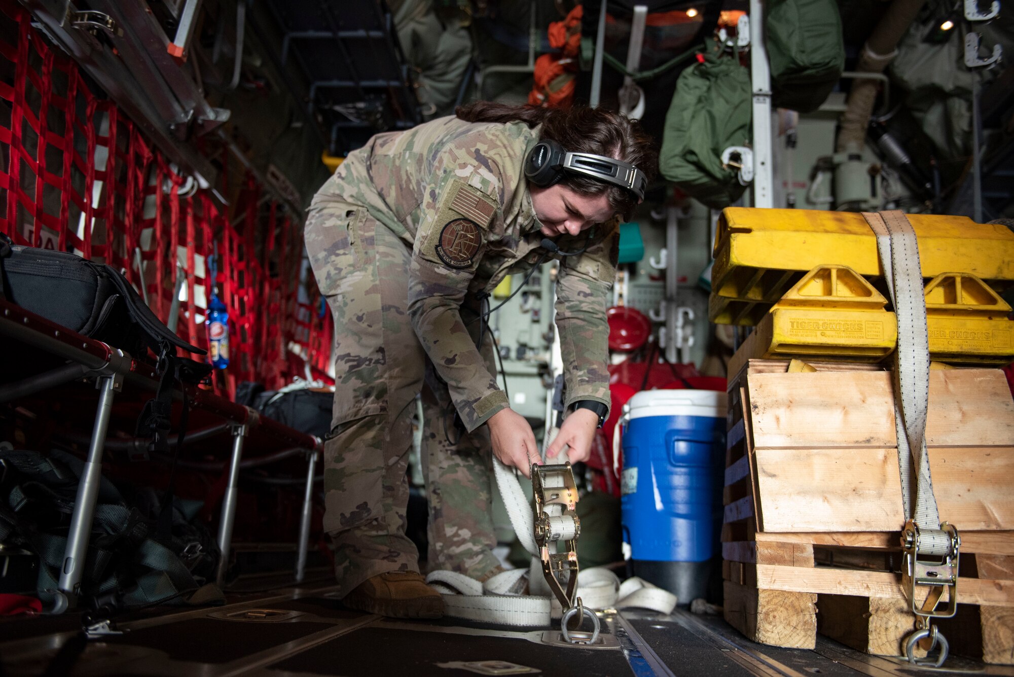 U.S. Air Force Staff Sgt. Caitlin Sexton, 71st Rescue Squadron loadmaster, tightens an equipment belt on an HC-130J Combat King II aircraft at Hurlburt Field, Florida, Oct. 26, 2023. Loadmasters from the 71st RQS ensure the safe loading and transport of cargo, personnel and various assets on HC-130J Combat King II aircraft. (U.S. Air Force photo by Staff Sgt. Thomas Johns)
