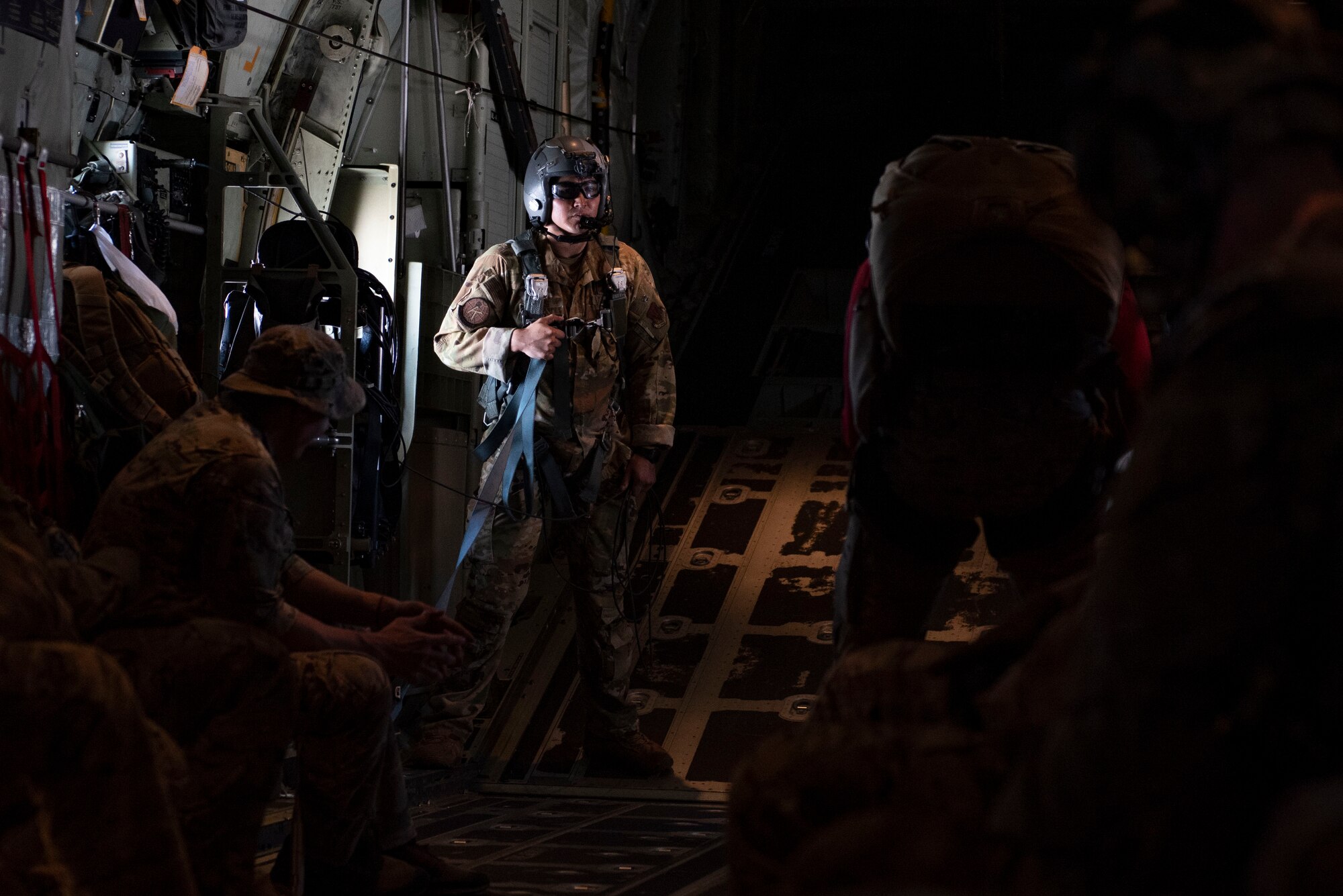U.S. Air Force Senior Airman Damien Elias, 71st Rescue Squadron loadmaster, prepares Special Operations Warfare Airmen for jump training above Hurlburt Field, Florida, Oct. 26, 2023. Loadmasters from the 71st RQS ensure the safe loading and transport of cargo, personnel, and various assets on HC-130J Combat King II aircraft. (U.S. Air Force photo by Staff Sgt. Thomas Johns)