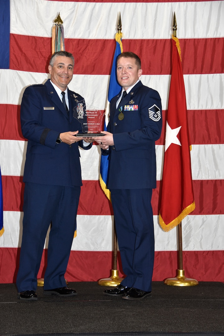 Maj. Gen. Paul Knapp, Wisconsin’s adjutant general, presents Master Sgt. Charles Ells with the 1st Lt. Thomas E. Wortham IV Award Oct. 27 at Joint Force Headquarters in Madison, Wis.