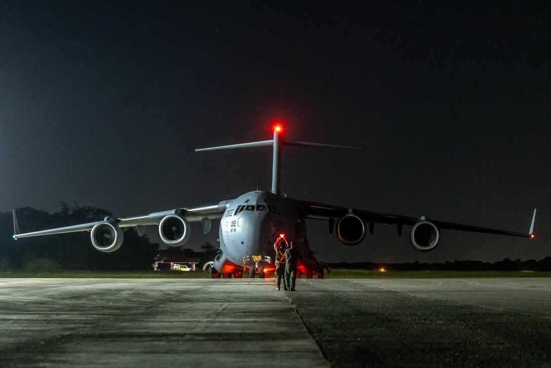 Brazilian airmen guide a U.S. Air Force C-17 Globemaster III on the flight line.