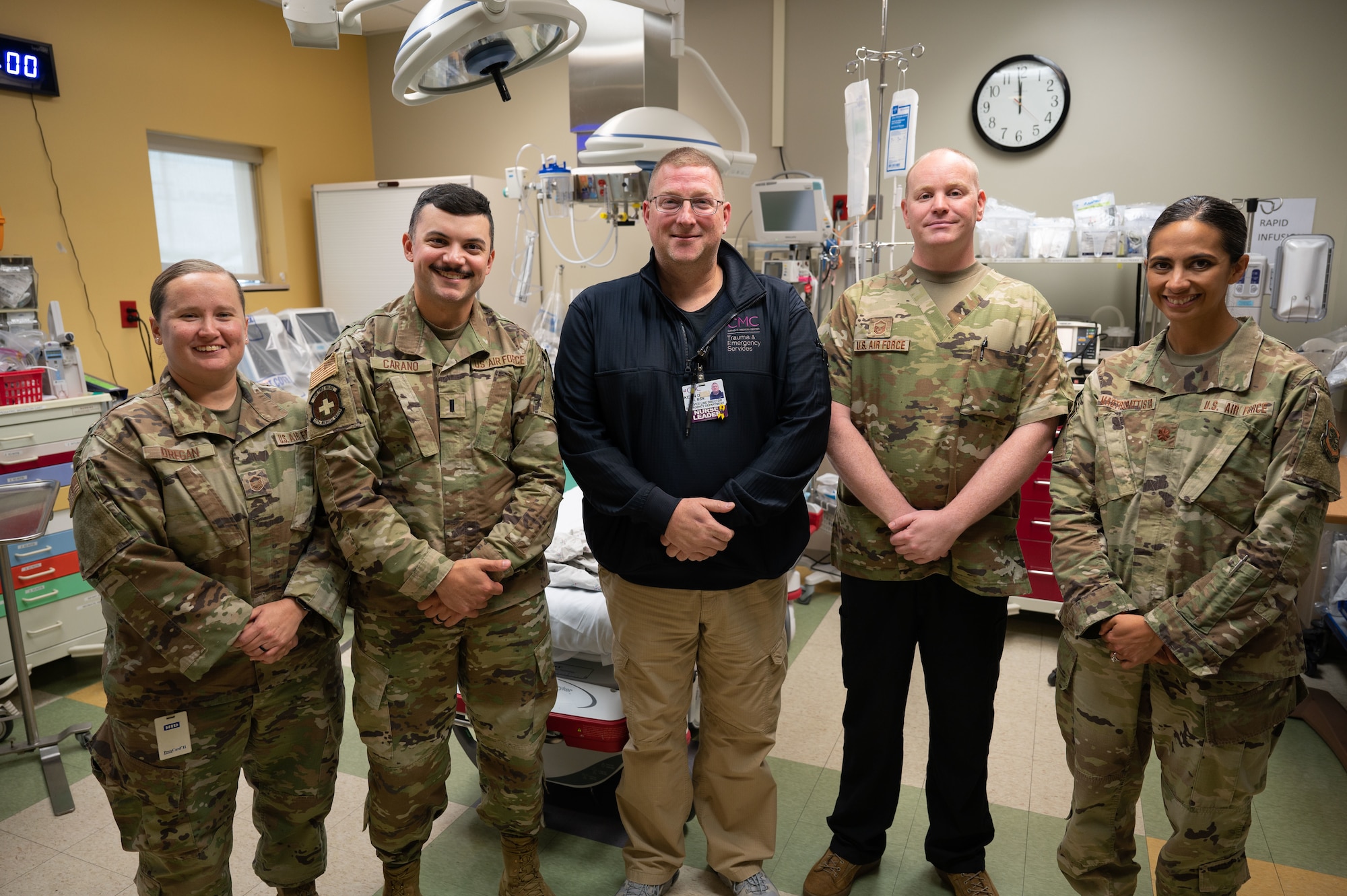 A team of Airmen from the 157th Medical Group and Kevin Drew, the Director of Emergency Services with Catholic Medical Center, discuss the pilot week of a new partnership Oct. 12, 2023 in the Emergency Department at CMC in Manchester, New Hampshire. The New Hampshire Air National Guard is one of only five other units in the country to create this type of agreement that allows New Hampshire Air National Guard medics to hone their skills with patients in the hospital setting. (U.S. Air National Guard photo by Tech. Sgt. Victoria Nelson)