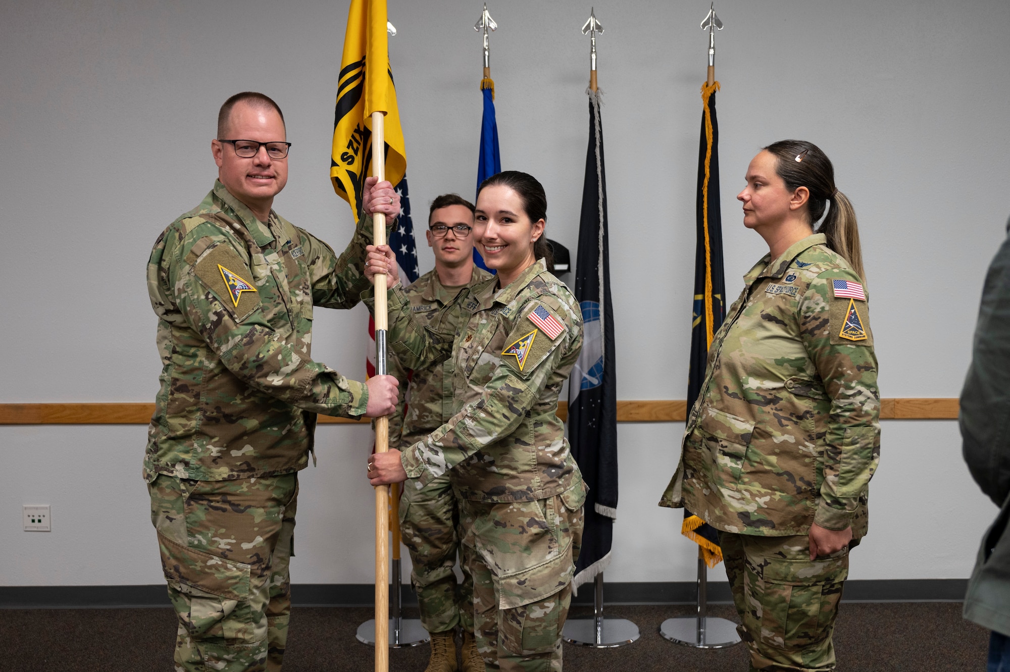 A man passes a guidon.