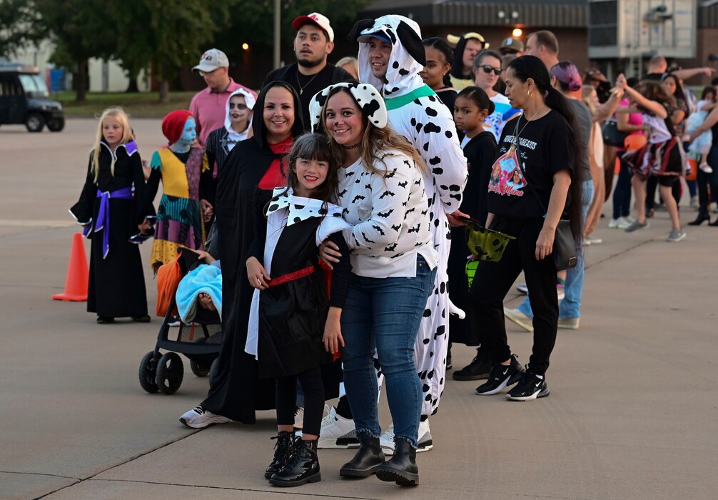 Event attendees smile for a photo during the Ghoulfellow Trunk or Treat event hosted at the Louis F. Garland Fire Academy, Goodfellow Air Force Base, Texas, Oct. 28, 2023. Nearly 2,000 people attended the Ghoulfellow Trunk or Treat. (U.S. Air Force photo by Airman 1st Class Madison Collier)