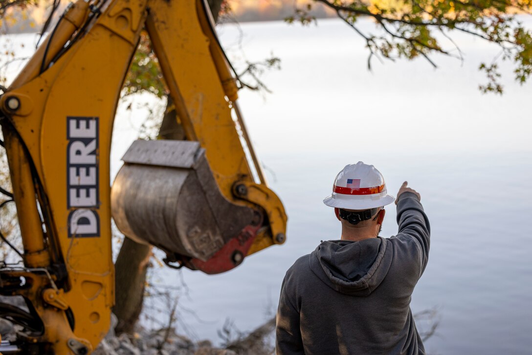 A maintenance mechanic with the U.S. Army Corps of Engineers Pittsburgh District completes a shoreline stabilization project work using a backhoe at Shenango River Lake.