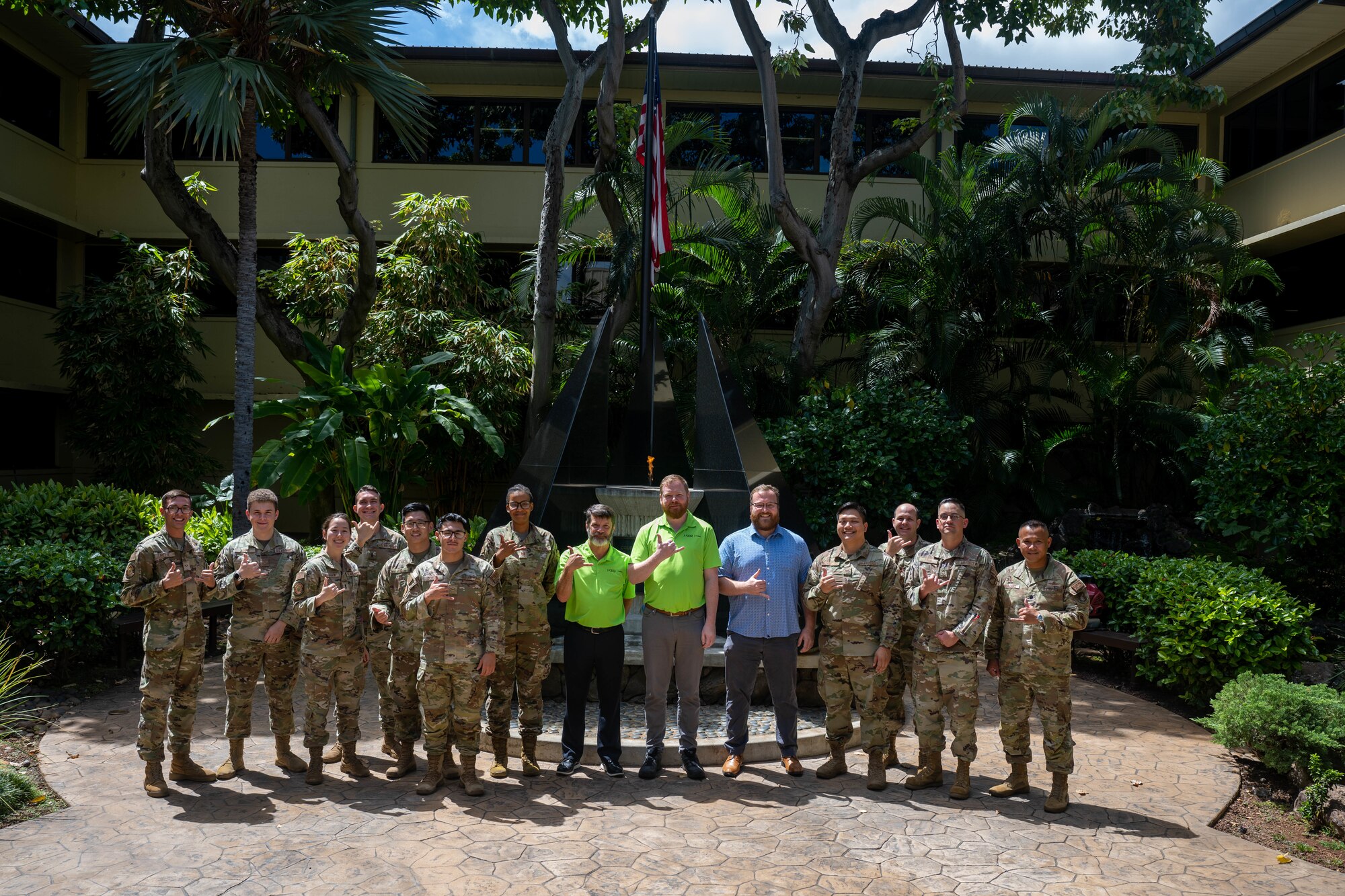 Airmen assigned to the 747th Cyberspace Squadron and industry partners pose for a group photo at Joint Base Pearl Harbor-Hickam, Hawaii, Oct. 10, 2023. The project was executed by 11 Airmen and three contractors during a 28 hour authorized service interruption period and increased network stability support of Hickam Air Field. (U.S. Air Force photo by Senior Airman Makensie Cooper)