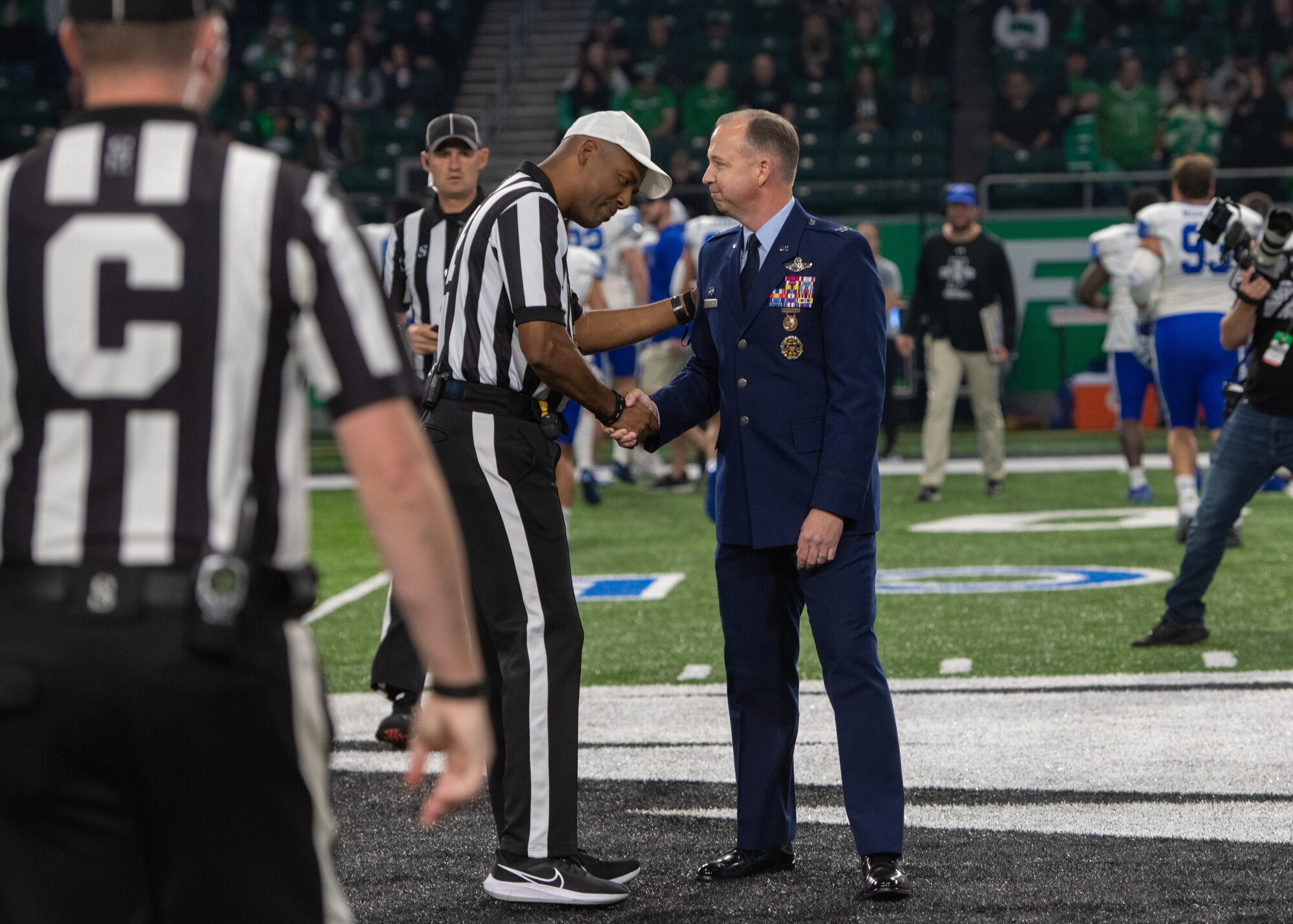 Two men shake hands.