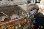 Maverick Gavidia, an infant patient at Walter Reed National Military Medical Center's Neonatal Intensive Care Unit (NICU), and her mother pose for a photo in Walter Reed's NICU in Bethesda, Maryland, Oct. 31, 2023. Maverick was dressed up to celebrate her first Halloween.