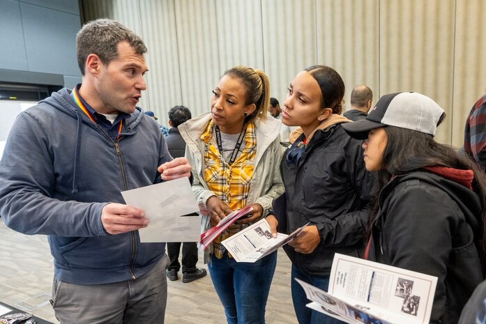 Joe Fenske, division head, Code 135, Non-Destructive Testing Division, talks with job seekers Oct. 20, 23, during the Puget Sound Naval Shipyard & Intermediate Maintenance Facility Hiring Fair at the Kitsap Conference Center in downtown Bremerton, Washington. The goal for this hiring event was to find more skilled trade employees for the command's production shops. (U.S Navy Photo by Wendy Hallmark)