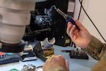 U.S. Air Force Tech Sgt. Nathan Atkinson, 509th Maintenance Group Air Force repair enhancement program technician, solders a board at Whiteman AFB, Mo., Oct. 31, 2023. AFREP engineers solutions for inefficient processes and damaged equipment. (U.S. Air Force photo by Airman 1st Class Robert Hicks)