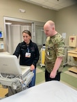 Heather Day-Lewis, an emergency department technician at Catholic Medical Center, and Master Sgt. John McDowell, an aerospace medicine technician with the 157th Medical Group, New Hampshire Air National Guard, work a shift together Oct. 10, 2023, in the Emergency Department at CMC in Manchester, New Hampshire