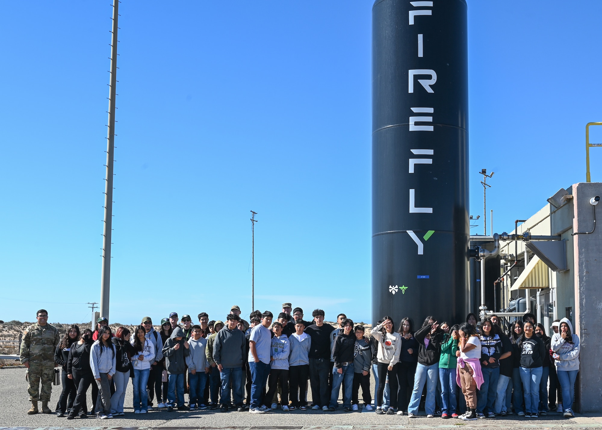 Vandenberg personnel and eighth graders visiting from Kermit McKenzie Intermediate School pose for a group photo.