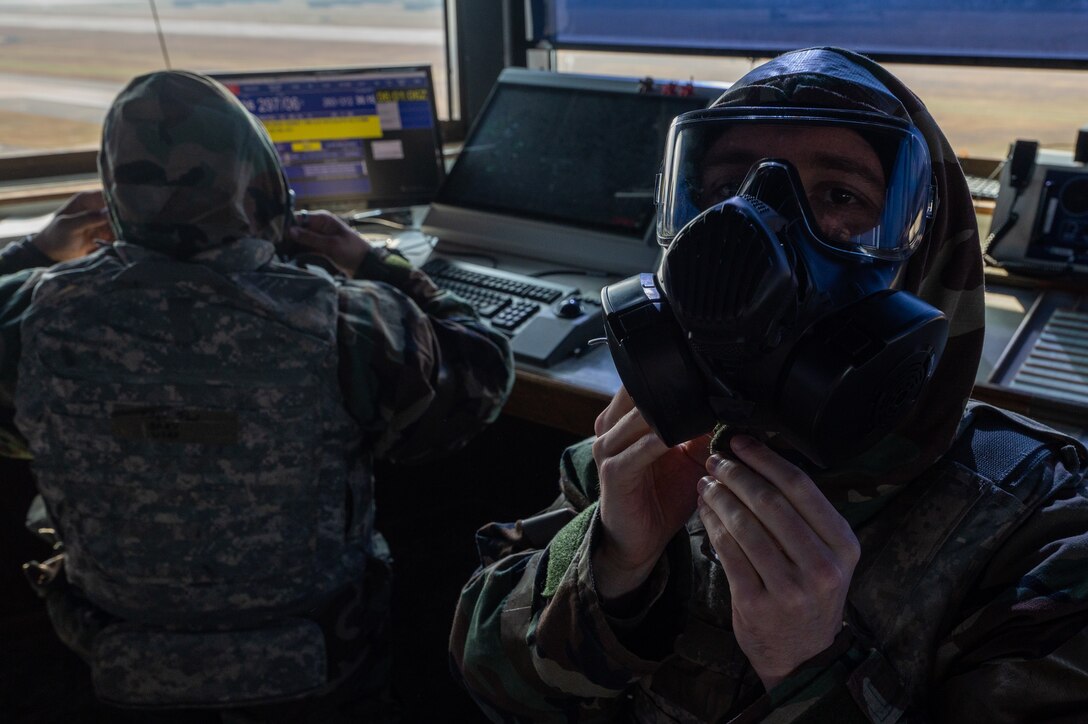 8th Operations Support Squadron air traffic control watch supervisors, don protective gear during Vigilant Defense 24 at Kunsan Air Base