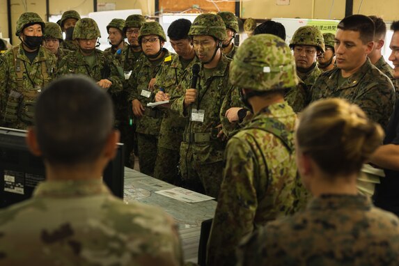 U.S. Marines with 12th Marine Regiment, 3d Marine Division, and Japan Ground Self-Defense Force service members with 8th Division, Western Army, operate in a bilateral coordination center during the field training exercise portion of Resolute Dragon 23 at Hijyudai Maneuver Area, Oita, Japan, Oct. 18, 2023. RD 23 is an annual bilateral exercise in Japan that strengthens the command, control, and multi-domain maneuver capabilities of Marines in III Marine Expeditionary Force and allied Japan Self-Defense Force personnel.  (U.S. Marine Corps photo by Cpl. Scott Aubuchon)