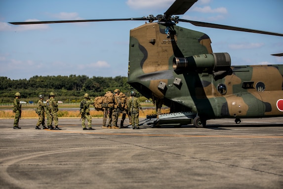 U.S. Marines with 2nd Battalion, 2nd Marine Regiment, board a Japan Ground Self-Defense Force CH-47JA Chinook with 3rd Squadron, Western Army Helicopter Unit, Western Army Aviation Group, during the field training exercise portion of Resolute Dragon 23 at JGSDF Camp Kengun Vice-Camp Takayubaru, Kumamoto, Japan, Oct. 17, 2023. RD 23 is an annual bilateral exercise in Japan that strengthens the command, control, and multi-domain maneuver capabilities of Marines in III Marine Expeditionary Force and allied Japan Self-Defense Force personnel. 2nd Battalion, 2nd Marine Regiment, is currently forward deployed in the Indo-Pacific under 4th Marine Regiment, 3d Marine Division. (U.S. Marine Corps photo by Cpl. Chloe Johnson)