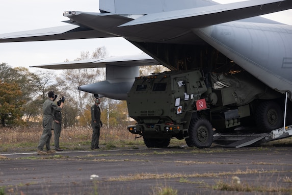 U.S. Marines with 3d Battalion, 12th Marine Regiment, 3d Marine Division, guide a High Mobility Artillery Rocket System from a KC-130J assigned to Marine Aerial Refueler Transport Squadron (VMGR) 152, Marine Aircraft Group 12, 1st Marine Aircraft Wing, during the field training exercise portion of Resolute Dragon 23 at Japan Air Self-Defense Force Kenebetsu Air Base, Hokkaido, Japan, Oct. 21, 2023. RD 23 is annual bilateral exercise in Japan that strengthens the command, control, and multi-domain maneuver capabilities of Marines in III Marine Expeditionary Forced and allied Japan Self-Defense Force personnel. (U.S. Marine Corps photo by Lance Cpl. Evelyn Doherty)