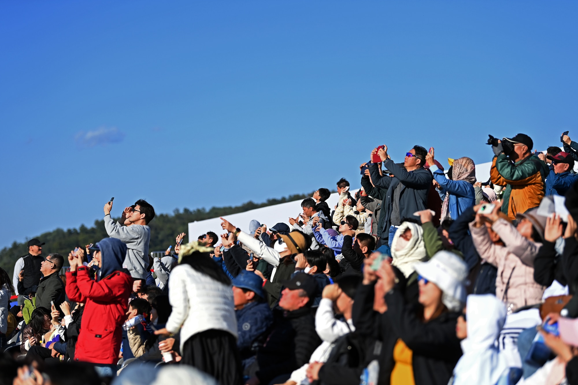 Visitors to the 2023 Seoul International Aerospace and Defense Exhibition view an aerial demonstration at Seoul Air Base, Republic of Korea, Oct. 21, 2023.