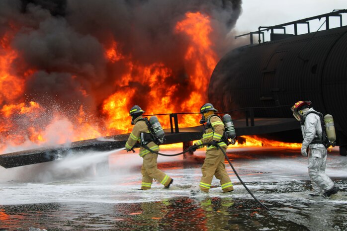 Firefighters from the Royal Canadian Armed Forces join the 801st Red Horse squadron for a hand line operation exercise