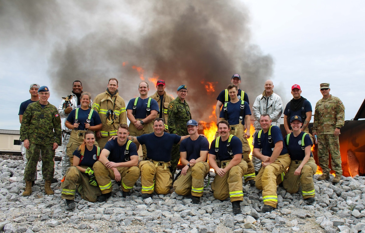 Firefighters from the Royal Canadian Armed Forces join the 801st Red Horse squadron for a hand line operation exercise