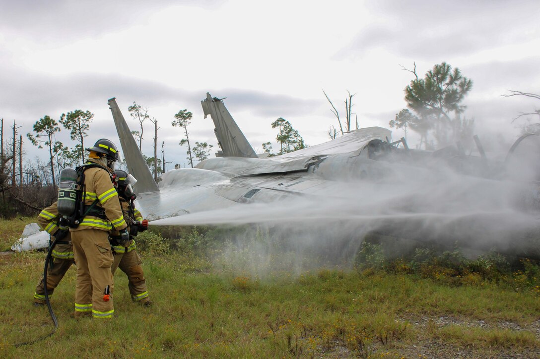 Firefighters from the Royal Canadian Armed Forces join the 801st Red Horse squadron for a hand line operation exercise