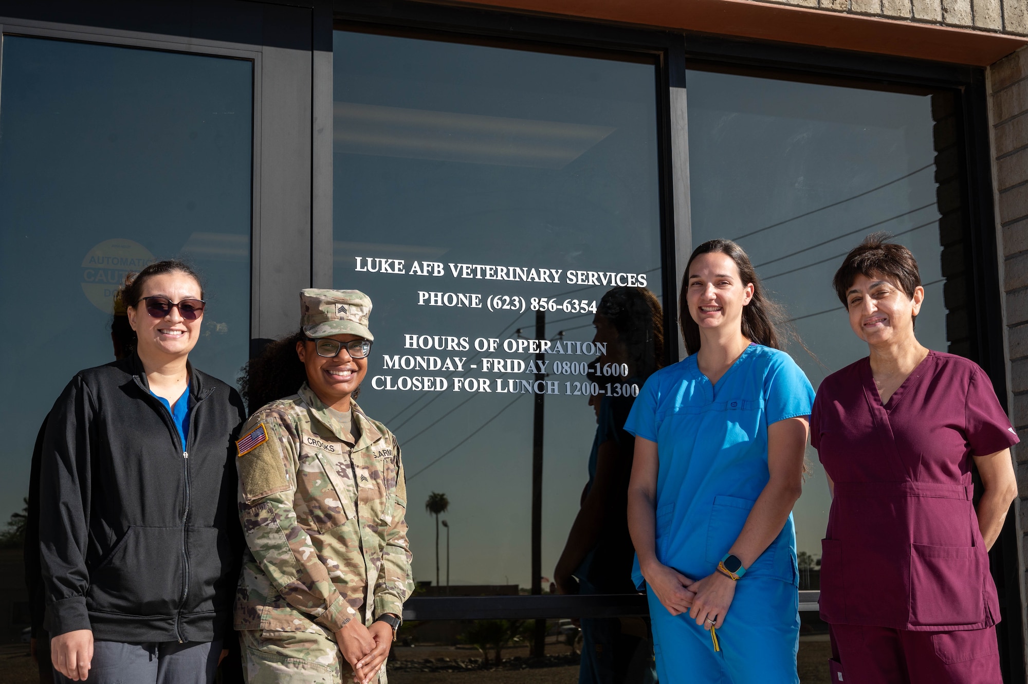 The Luke Air Force Base Veterinary Treatment Facility staff pose in front of their new building after a ribbon cutting ceremony, Oct. 23, 2023, at Luke Air Force Base, Arizona.