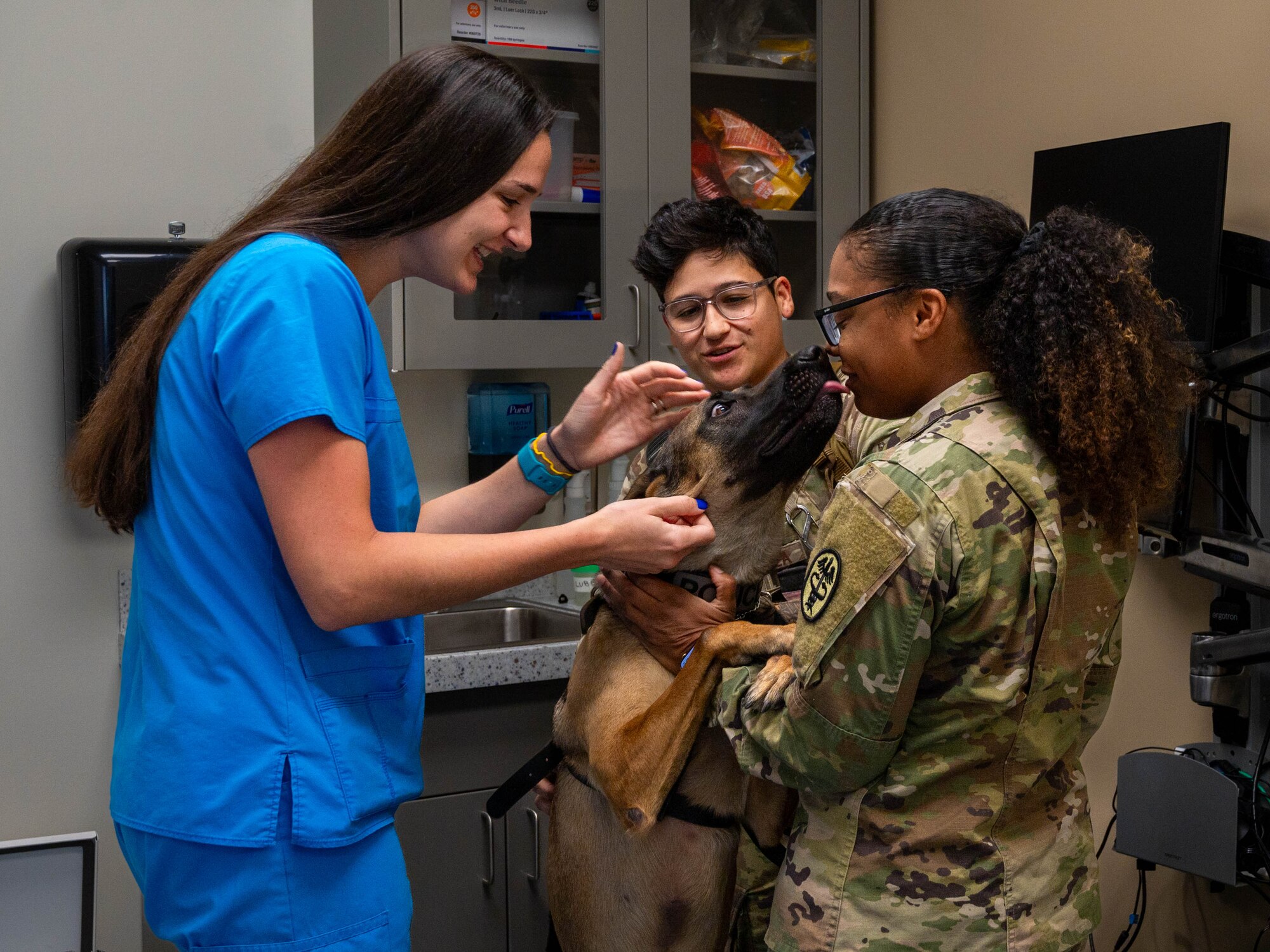 Dr. Rachel Hallman (left), Luke AFB Veterinary Treatment Facility veterinary medical officer, and U.S. Army Sgt. Ambria Crooks (right), Luke AFB Veterinary Treatment Facility noncommissioned officer in charge, interact with Bboa, military working dog, Oct. 23, 2023, at Luke Air Force Base, Arizona.