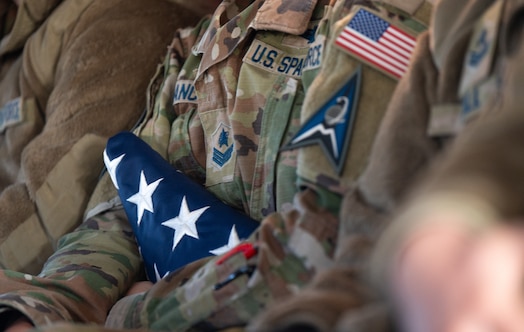  American flag is held by U.S. Guardian during a flight on a CH-47 Chinook over Fort Carson, Colorado.