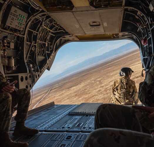  U.S. Army Soldier watches out of the back of a CH-47 Chinook flying over Fort Carson, Colorado.