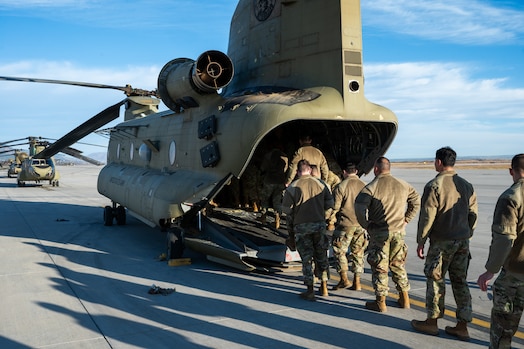  Guardians load onto a U.S. Army CH-47 Chinook for a partnership effort reenlistment flight.