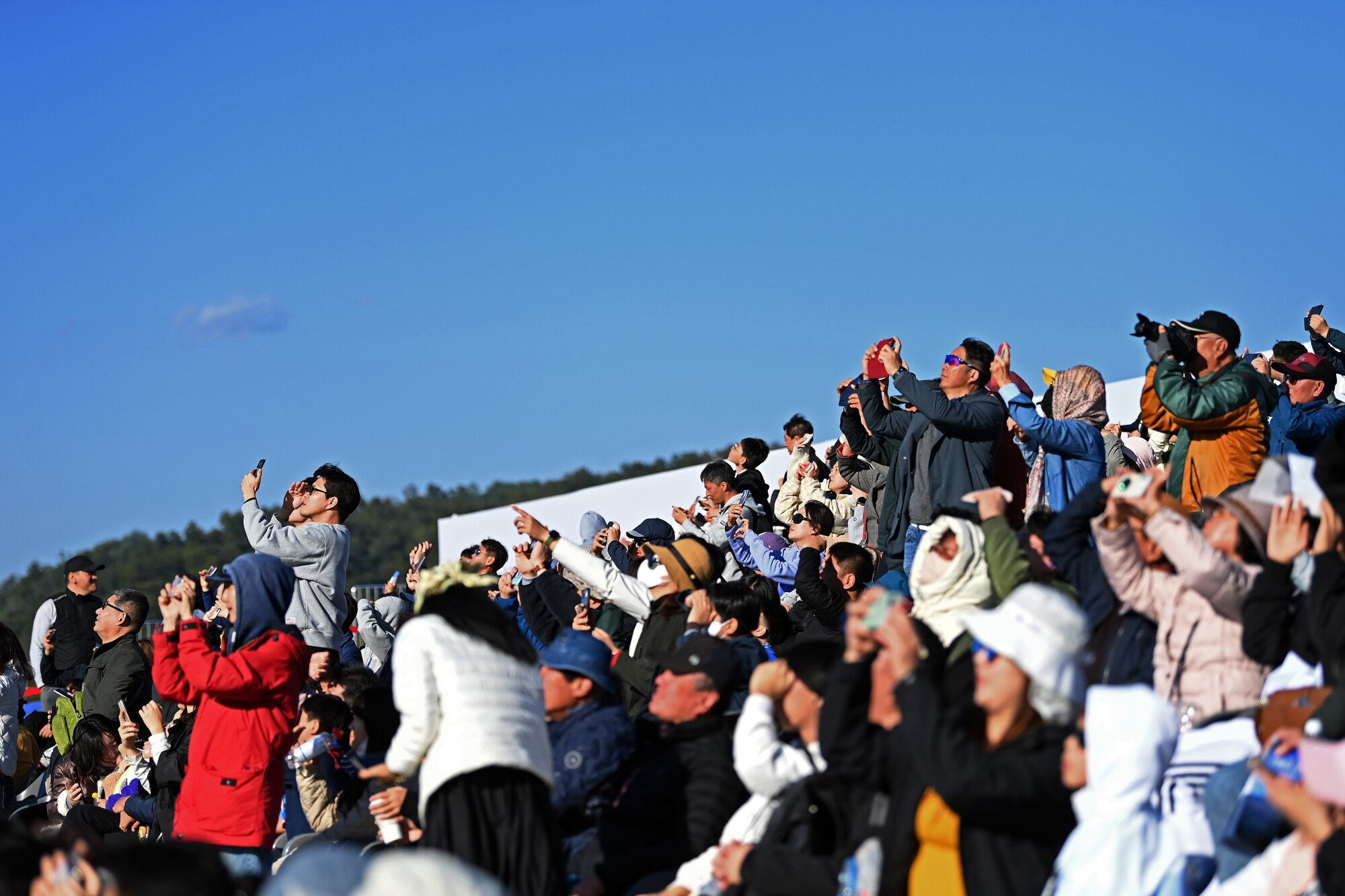 Visitors to the 2023 Seoul International Aerospace and Defense Exhibition view an aerial demonstration at Seoul Air Base, Republic of Korea, Oct. 21, 2023.