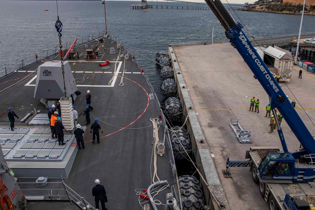 Sailors work on the deck of a ship.