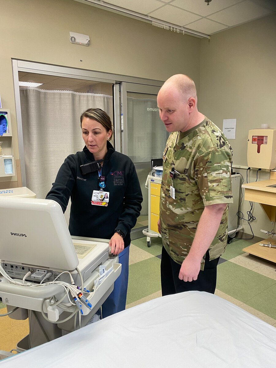 Heather Day-Lewis, an emergency department technician at Catholic Medical Center, and Master Sgt. John McDowell, an aerospace medicine technician with the 157th Medical Group, work a shift together Oct. 10, 2023 in the Emergency Department at CMC in Manchester, New Hampshire. McDowell was the first medic to pilot a new partnership between the New Hampshire Air National Guard and CMC that allows Airmen to hone their skills with patients in the hospital setting.