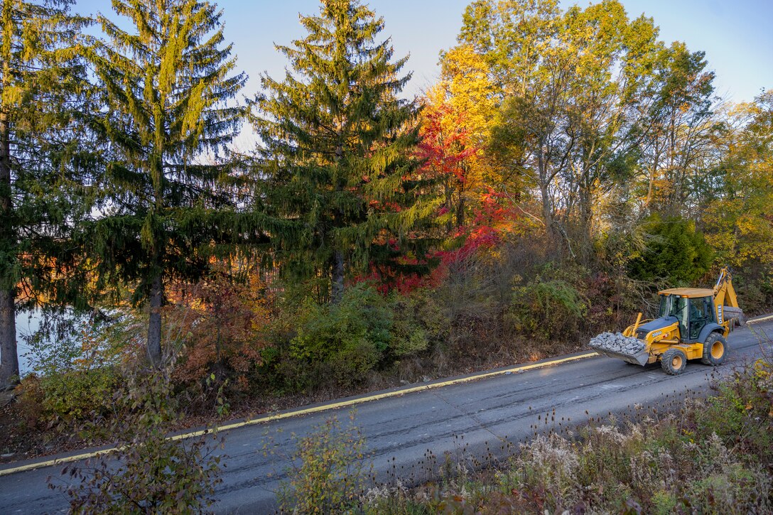 A maintenance mechanic with the U.S. Army Corps of Engineers Pittsburgh District completes a shoreline stabilization project work using a backhoe at Shenango River Lake.