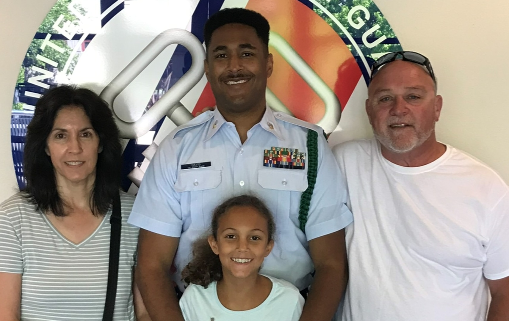Petty Officer 1st Class Benjamin Davis, center, with daughter Emma and his parents at Training Center Petaluma, Calif., in 2022.