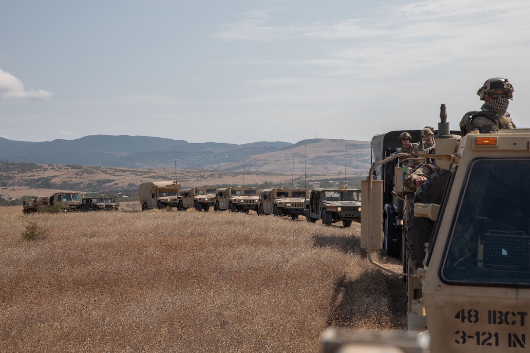 Soldiers ride in a convoy during a training exercise.