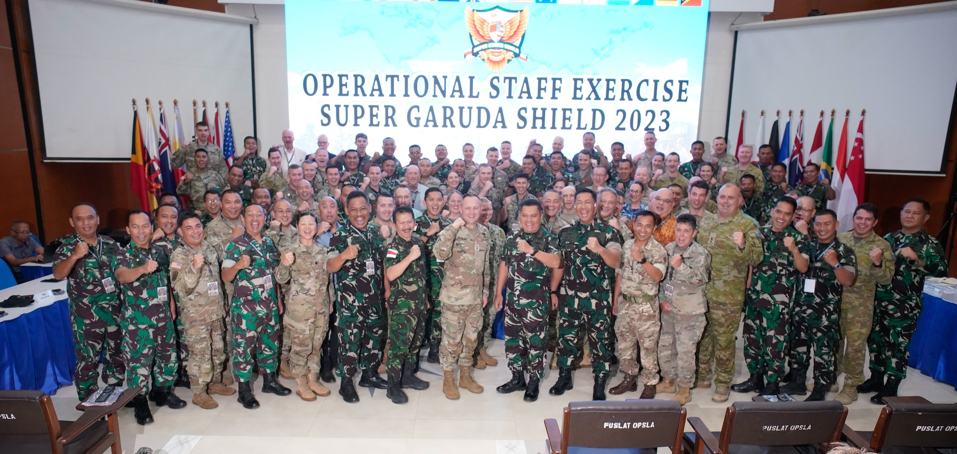 The participants of staff exercise portion of Super Garuda Shield 2023 (SGS23) pose for a group photo after the opening ceremony, August 31, 2023, Surabaya Indonesia. #SuperGarudaShield 2023 is an annual exercise that has significantly grown in scope and size since 2009. #SGS2023 is the second consecutive time this exercise has grown into a combined and #joint event, highlighting the 6 participating and 12 observing nations’ commitment to #partnership and a #freeandopenindopacific. (US Air National Guard Photo by Air Force Master Sgt. Andrew Lee Jackson)