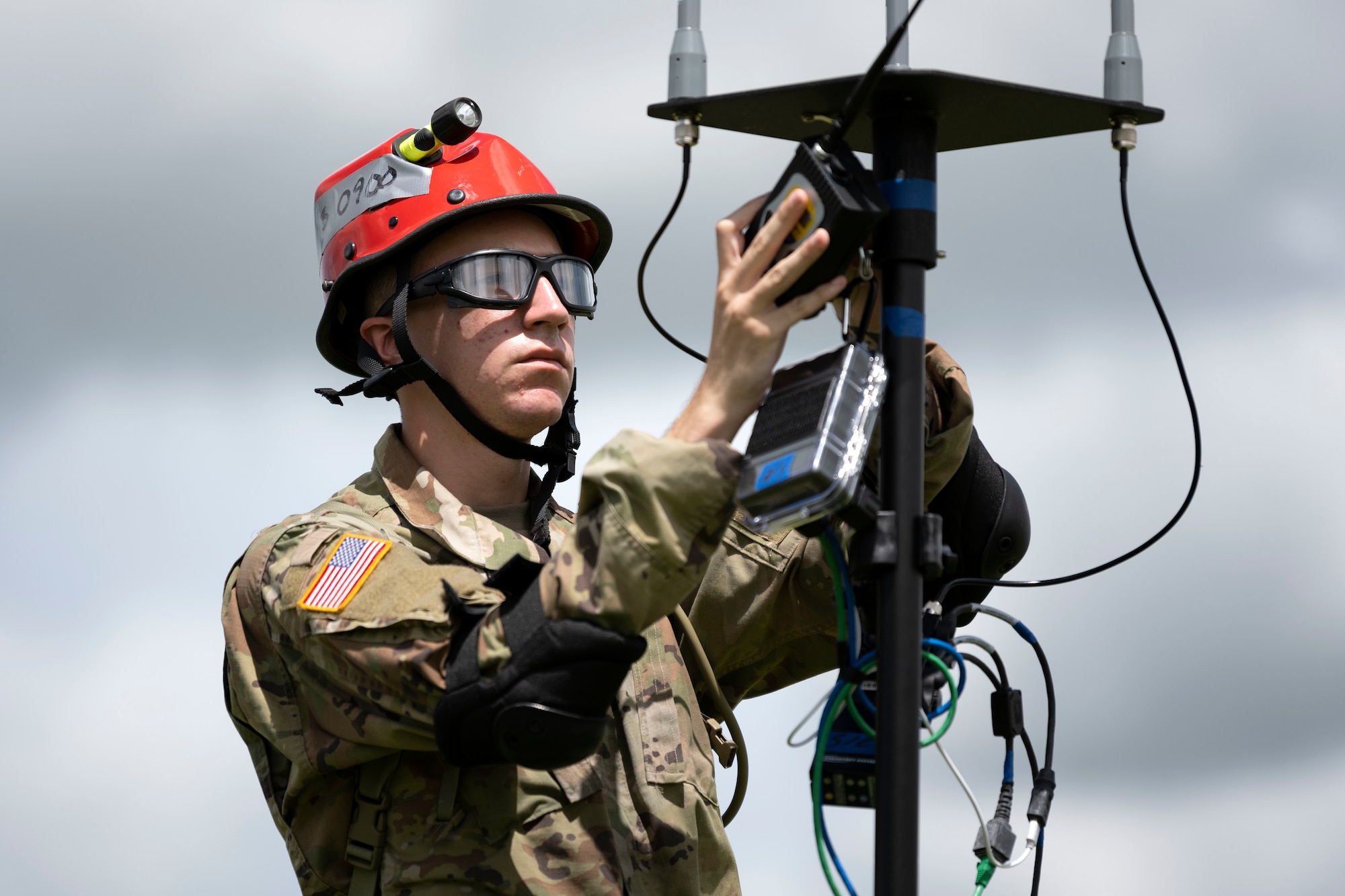 A U.S. Soldier assigned to the Puerto Rico Army National Guard connects equipment during a collective training exercise at Camp Santiago Joint Training Center, Salinas, Puerto Rico, Aug. 10, 2023. The exercise allowed service members assigned to the 156th Medical Group, 123rd Medical Group and the Puerto Rico Army National Guard to exchange knowledge and implement the National Guard CBRN Response Enterprise Information Management System, which assists with accelerating data collection from search and extraction teams in emergency events. (U.S. Air National Guard photo by Master Sgt. Rafael D. Rosa)