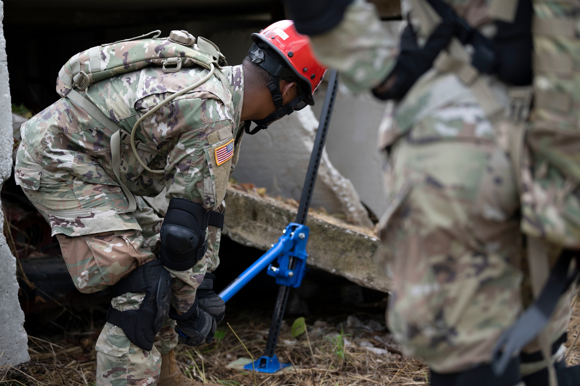 A U.S. Soldier assigned to the Puerto Rico Army National Guard lifts heavy debris during a collective training exercise at Camp Santiago Joint Training Center, Salinas, Puerto Rico, Aug. 10, 2023. The exercise allowed service members assigned to the 156th Medical Group, 123rd Medical Group and the Puerto Rico Army National Guard to exchange knowledge and implement the National Guard CBRN Response Enterprise Information Management System, which assists with accelerating data collection from search and extraction teams in emergency events. (U.S. Air National Guard photo by Master Sgt. Rafael D. Rosa)