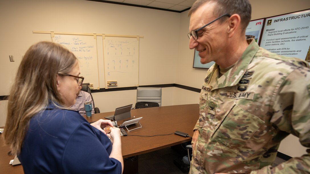 Col. Rhett Blackmon, U.S. Army Corps of Engineers (USACE), Galveston District (SWG) commander, presents Donna Williams, USACE, New Orleans District (MVN), Internal Review (IR) chief, with his commander’s coin at the Jadwin Building, Aug. 31, 2023.