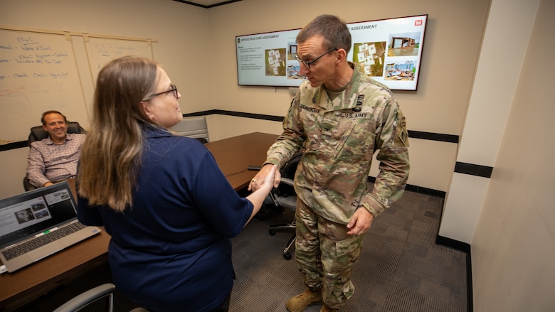 Col. Rhett Blackmon, U.S. Army Corps of Engineers (USACE), Galveston District (SWG) commander, presents Donna Williams, USACE, New Orleans District (MVN), Internal Review (IR) chief, with his commander’s coin at the Jadwin Building, Aug. 31, 2023, as Geoffrey Veuleman, SWG IR auditor observes.