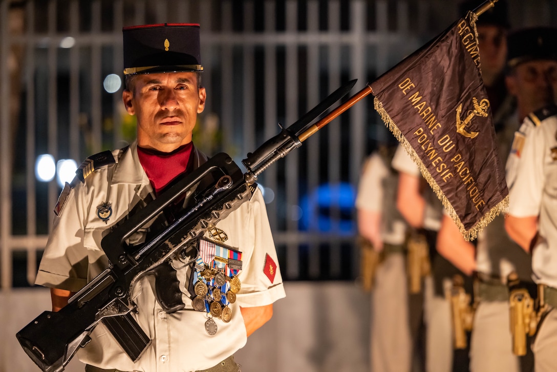 A member of the French Marine Infantry Regiment in French Polynesia, French Armed Forces stands at parade rest during the Bazeilles Day Ceremony in Arue, Tahiti, French Polynesia, Aug. 31, 2023. The Bazeilles Day Ceremony commemorates a pivotal moment for the French Armed Forces during the Franco-Prussian War in 1870, where French Marines were outnumbered by their enemy 10-to-1 during one of the first recorded occurrences of urban warfare. Pacific Marines’ presence at the ceremony demonstrates the collective effort in strengthening relationships and building upon mutual respect among Allies in support of a free and open Indo-Pacific region. (U.S. Marine Corps photo by Cpl. Haley Fourmet Gustavsen)