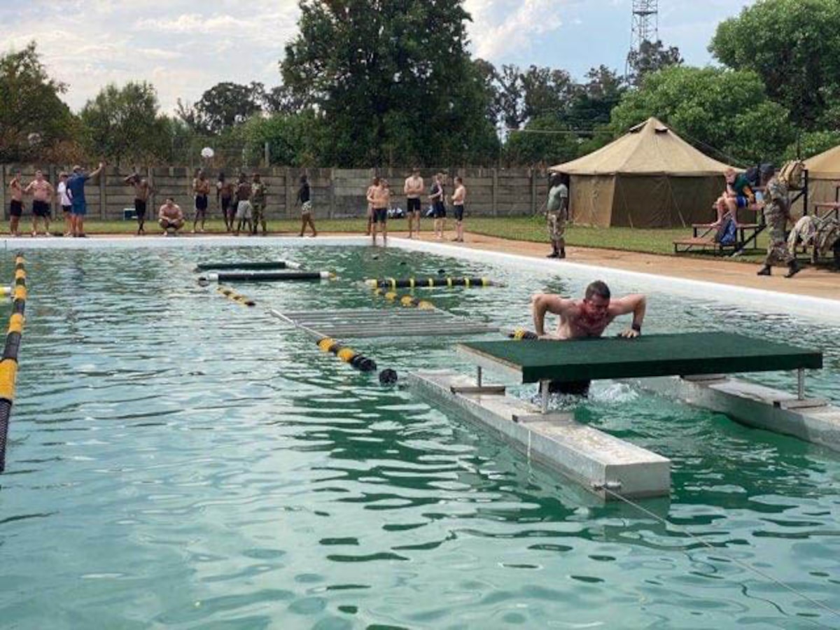 A New York National Guard Soldier negotiates the water obstacle course at the South African National Defence Force Military Skills Competition in Potchefstroom, South Africa, in October 2022. The New York National Guard will send 15 Soldiers and Airmen to the 2023 competition Sept. 9-16.