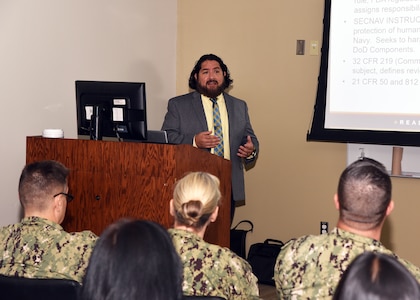 OINT BASE SAN ANTONIO-FORT SAM HOUSTON – (Aug. 31, 2023) – Dr. Luis Martinez, of San Angelo, Texas, a research microbiologist, assigned to the Craniofacial Health and Restorative Medicine Directorate, Naval Medical Research Unit (NAMRU) San Antonio, speaks on purpose and composition of the command’s Institutional Review Board (IRB) during the sixth edition of “Mission Possible,” an information-sharing event held at the Tri-Service Research Laboratory. The purpose of “Mission Possible” is to better inform members of the command on the tactics, techniques, and procedures of the science directorates to include the resource acquisitions and administrative directorates. NAMRU San Antonio’s mission is to conduct gap driven combat casualty care, craniofacial, and directed energy research to improve survival, operational readiness, and safety of Department of Defense (DoD) personnel engaged in routine and expeditionary operations. It is one of the leading research and development laboratories for the U.S. Navy under the DoD and is one of eight subordinate research commands in the global network of laboratories operating under the Naval Medical Research Command in Silver Spring, Md. (U.S. Navy photo by Burrell Parmer, NAMRU San Antonio Public Affairs/Released)