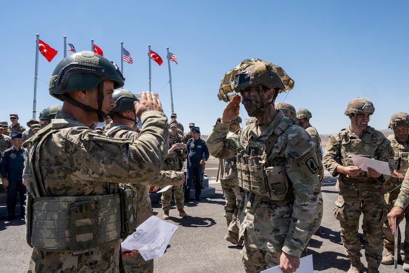 Turkish and U.S. forces exchange salutes.